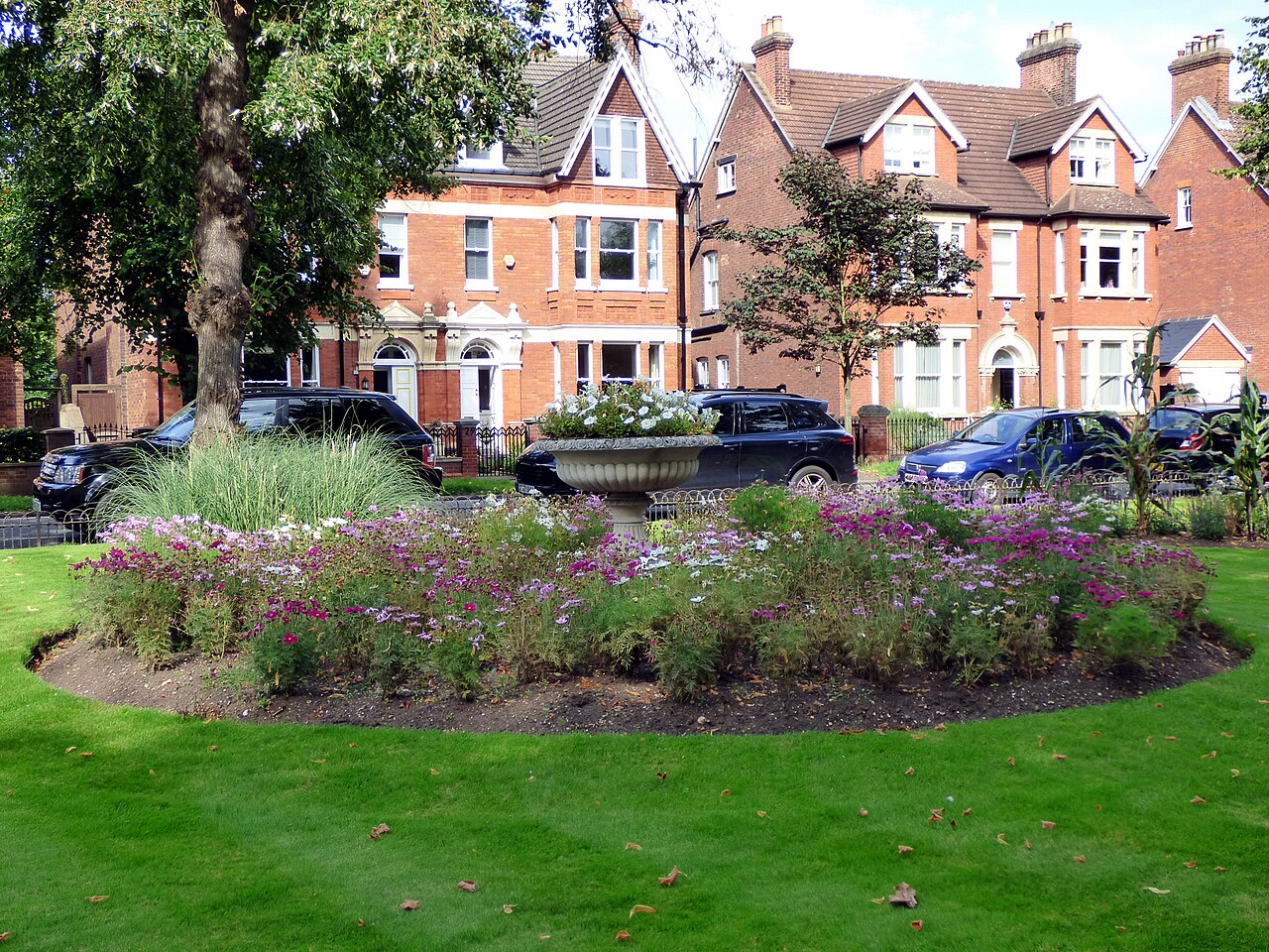 Flower beds and brick houses beside Bedford’s Embankment