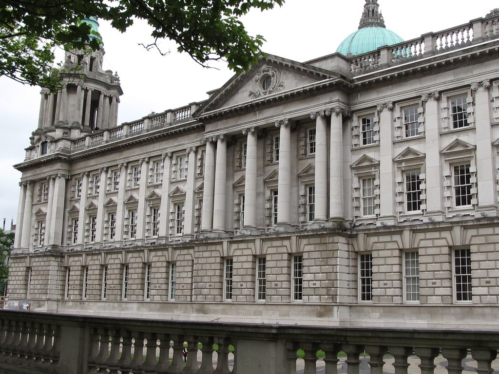 Stone columns and green domes on the western facade of Belfast City Hall