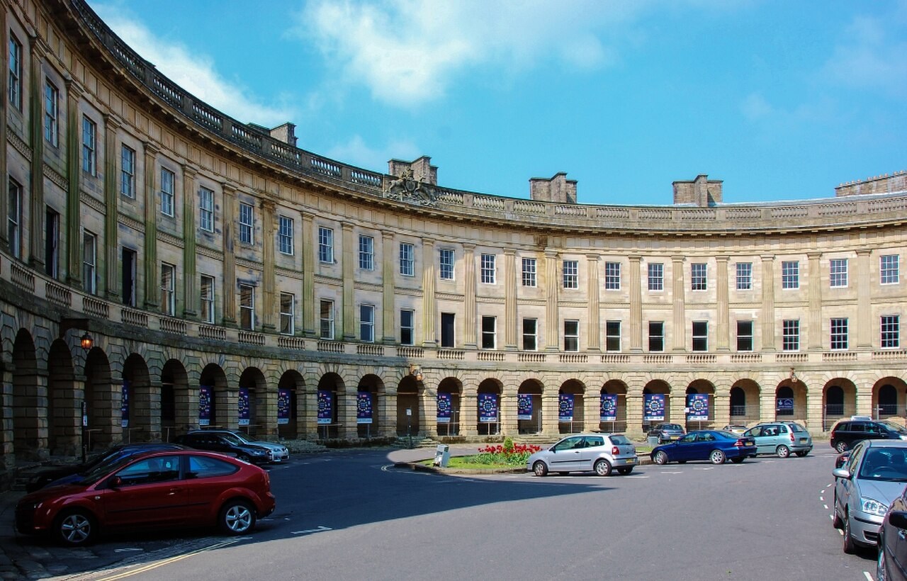 Curving Georgian facade and colonnade of the Crescent in Buxton