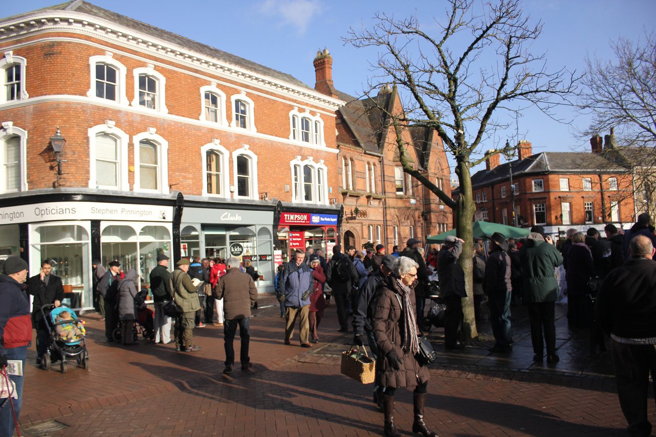 People gathered in Nantwich town square beside its historic buildings