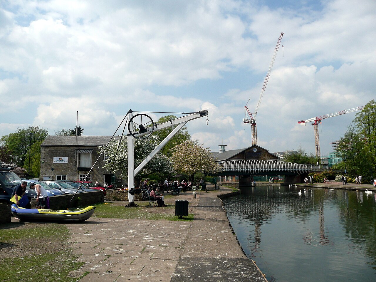 Historic crane beside the canal and footbridge at Newbury Wharf